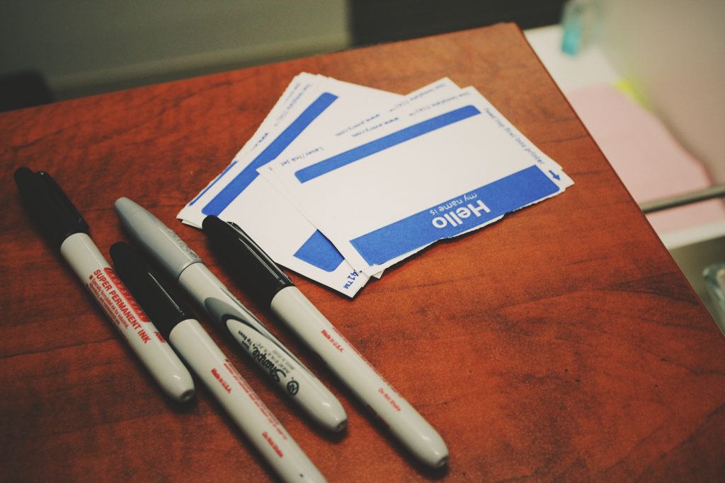 Welcome desk with sharpie markers and "Hello, My Name Is" stickers.