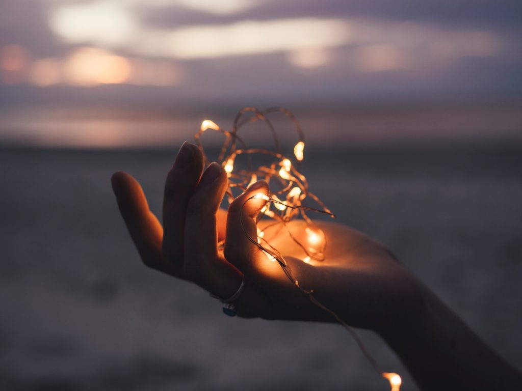 hand holding a ball of light filaments